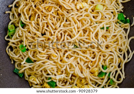 Close up of stir-fry noodles in wok pan