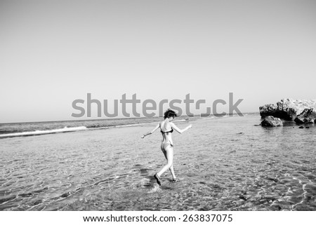 Photo of the girl in swimsuit run by water, black and white, Egypt