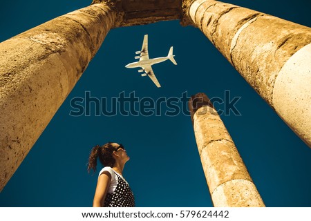 Young woman look at airplane dreaming about vacation. Explore the world. Export concept. Time to travel. Freedom life. Independent person. Tourism and transportation industry. Spirit of adventure.