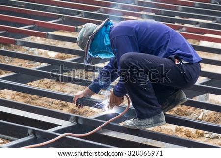 local metal worker is welding steel structure for new house terrace, Thailand