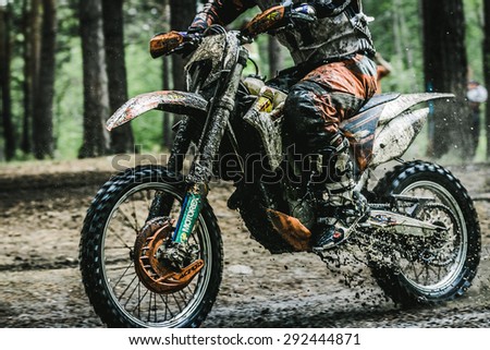 Kyshtym, Russia - June 21, 2015: Motocross driver on muddy offroad track during the race Urals Cup of Enduro \