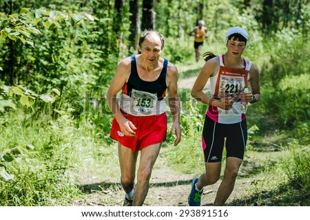 Miass, Russia - June 28, 2015: old man and the girl run during marathon \