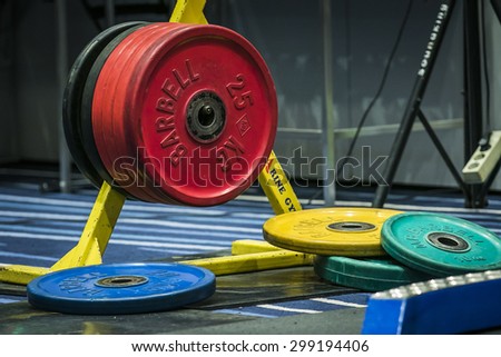 Chelyabinsk, Russia - July 17, 2015: Disks from barbell on the rack during National championship powerlifting, bench press and deadlift, Chelyabinsk, Russia - July 17, 2015