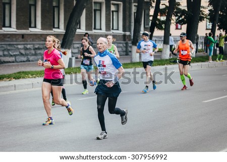 Ekaterinburg, Russia - August 01, 2015:  old man runner competes during Marathon From Europe To Asia, Ekaterinburg, Russia - August 01, 2015