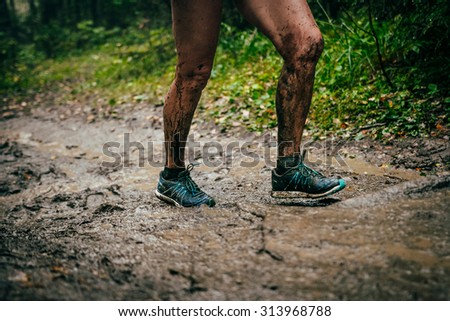 Zlatoust, Russia - August 30, 2015: closeup feet male athlete in mud during mountain marathon \