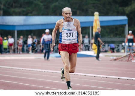 Chelyabinsk, Russia - August 28, 2015:  75 year old man runs during championship of Russia on track and field athletics among the elderly, Chelyabinsk, Russia - August 28, 2015