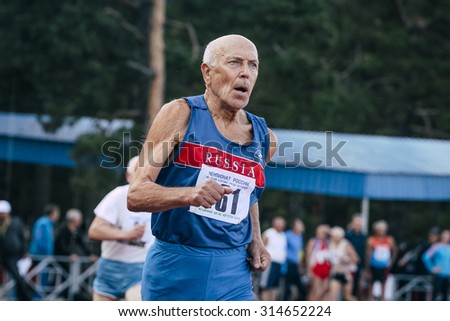 Chelyabinsk, Russia - August 28, 2015:  old man runs 400 meters during championship of Russia on track and field athletics among the elderly, Chelyabinsk, Russia - August 28, 2015