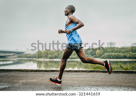 Omsk, Russia -  September 20, 2015: Kenyan John Kyui runs along the river during Siberian international marathon