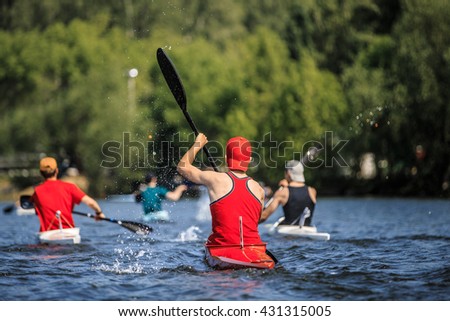 group of athletes canoeists boating on  lake in a kayak. water spray from oars