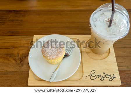 Ice coffee and Milk Cake on wood board