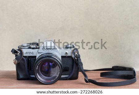 Saturday, 25 April 2015: in Chiangmai Thailand , Canon AT-1 (film camera) on wood table and vintage background