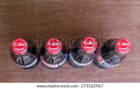 Wednesday, 29 April 2015 : in Chiang Mai Thailand,Coke cap on Coca cola bottler on wood Background.
