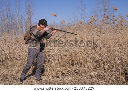 Hunter prepares to shoot wild boar
