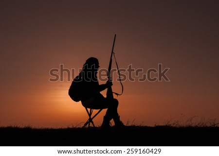Woman Hunter Silhouetted in Sunset