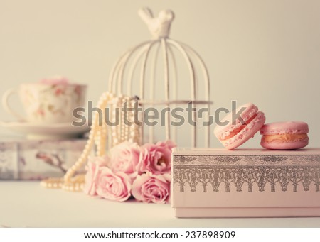 Soft pastel vintage still life with macaroons and roses