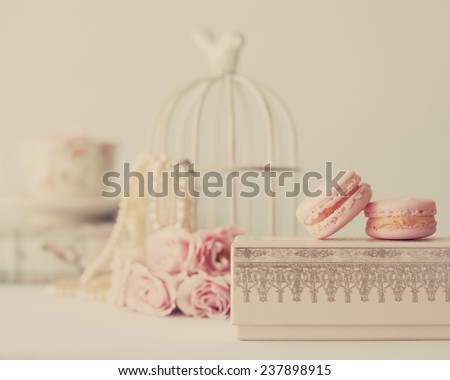 Soft pastel vintage still life with macaroons and roses