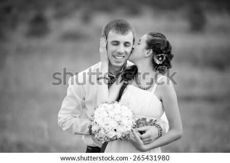 wedding couple in national costume in meadow