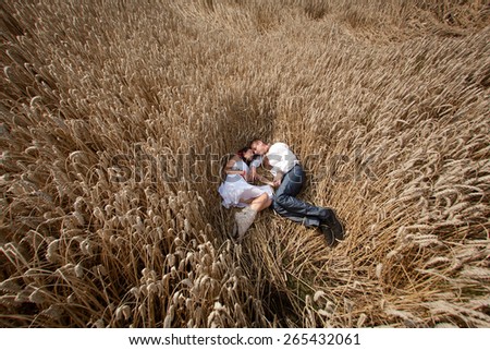wedding couple in national costume in wheat