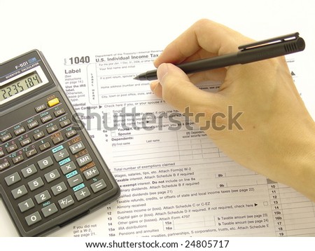 Filling federal tax forms with a calculator and a pen