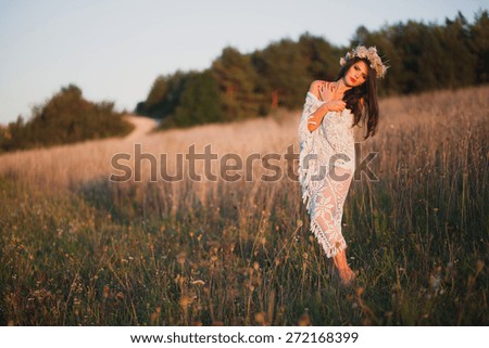 Beautiful girl on the field and sunset, Indian Summer