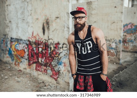 young handsome fashion bearded model man in urban context