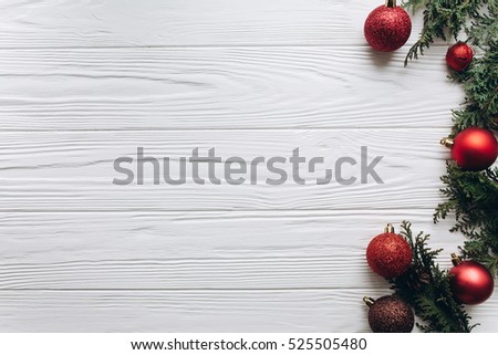 Christmas decorations, gifts and food on a white wooden background.