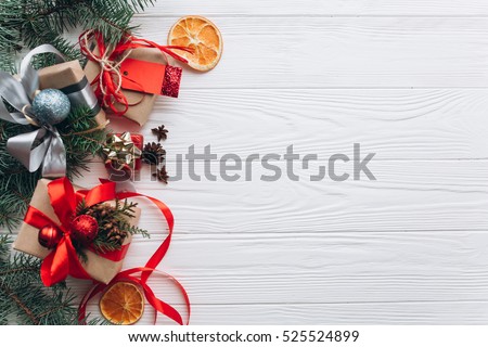 Christmas decorations, gifts and food on a white wooden background