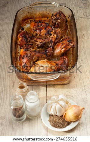 rabbit meat roaster with onion cumin and garlic on wooden vintage table