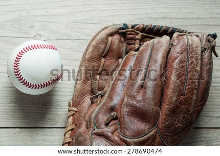 Old and worn used leather baseball sport glove over aged
