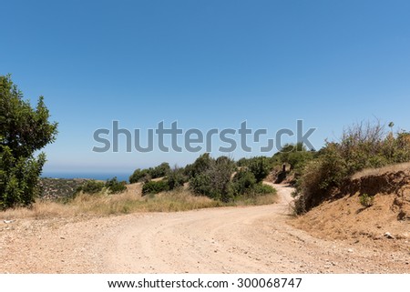 Winding mountain dirt road and foliage on Cyprus