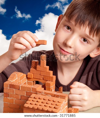 Boy building house isolated on white