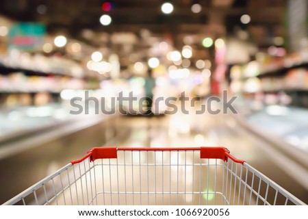 shopping cart with Abstract supermarket grocery store refrigerator blurred defocused background with bokeh light