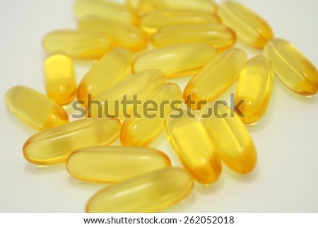 many Fish Oil omega 3 soft gel capsules On White Background