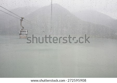 many water drops in cable car way to mountains above the sea