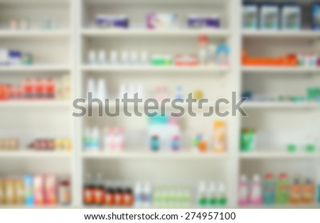 blur some shelves filled with medication in a pharmacy drugstore