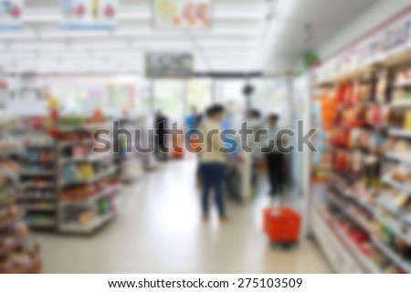 convenience store cashier with customers blur background