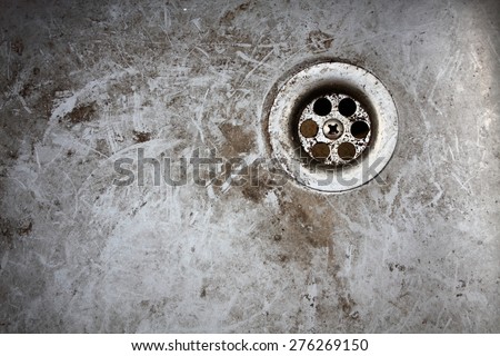 very old dirty sink with rusty metal drain closeup