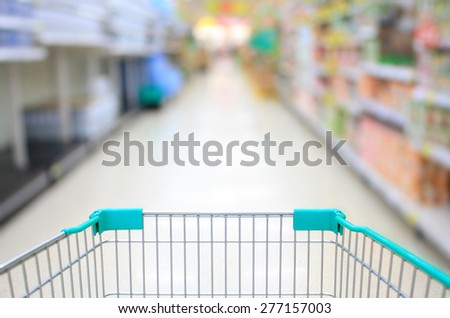 Shopping Cart View in Supermarket Aisle and Shelves defocus background