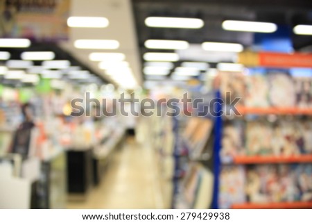 Abstract blurred photo of book store shelves with people in shopping mall