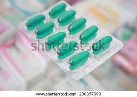 closeup blue medicine soft gel capsule blister on pharmacy drugstore background