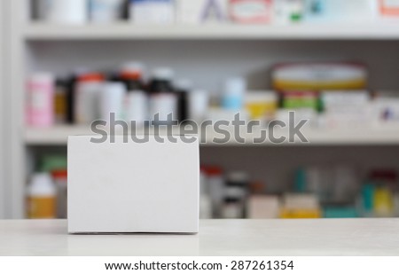 Blank white medicine box with blur shelves of drug in the pharmacy drugstore background