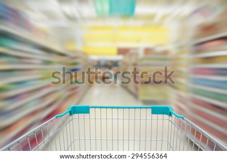 supermarket aisle with shopping cart in motion blur