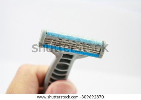 Hand with shaving razor isolated on a white background