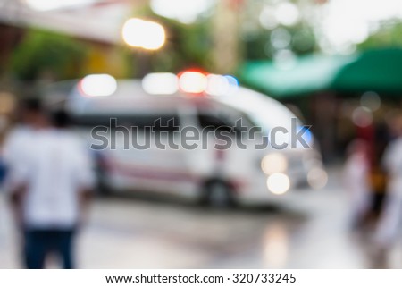 Ambulance responding to an emergency call blurred background