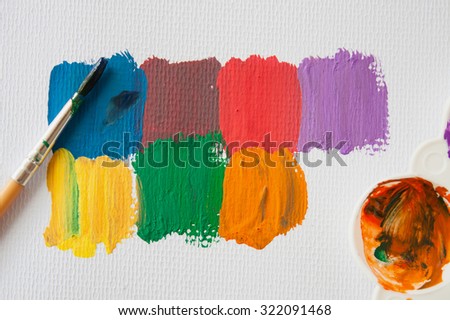 paint brush with color plate on watercolor paint paper