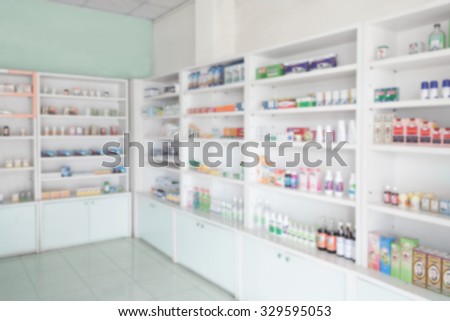 Pharmacy store interior with blurred shelves of drugs background
