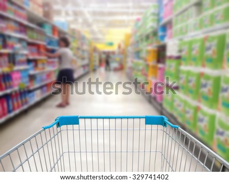 supermarket shelves aisle blurred background with shopping cart