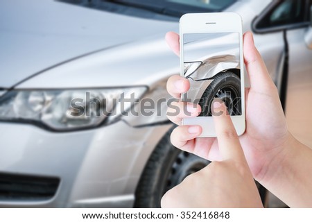 female photographing her vehicle with damages for accident insurance