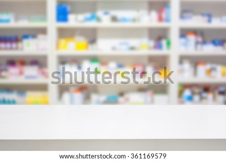 pharmacy counter with blur shelves of drug in the drugstore background