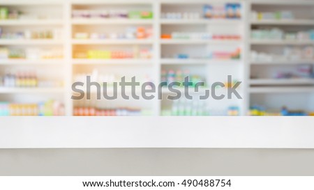 wood counter with blur shelves of drug in the pharmacy drugstore background